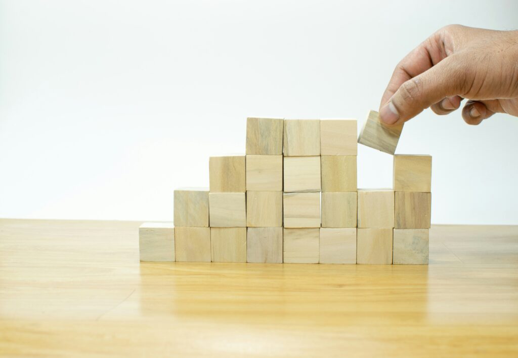 Someone arranging building blocks as a growth curve